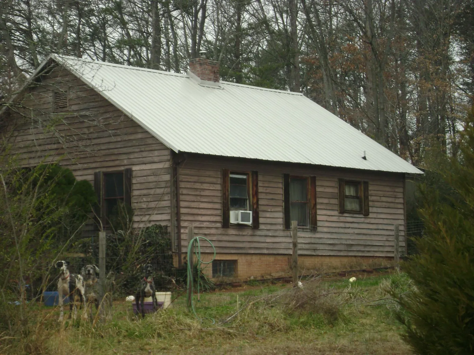White metal roof on an old wood sided farmhouse, from a Metal Roof Installation job in Hustisford